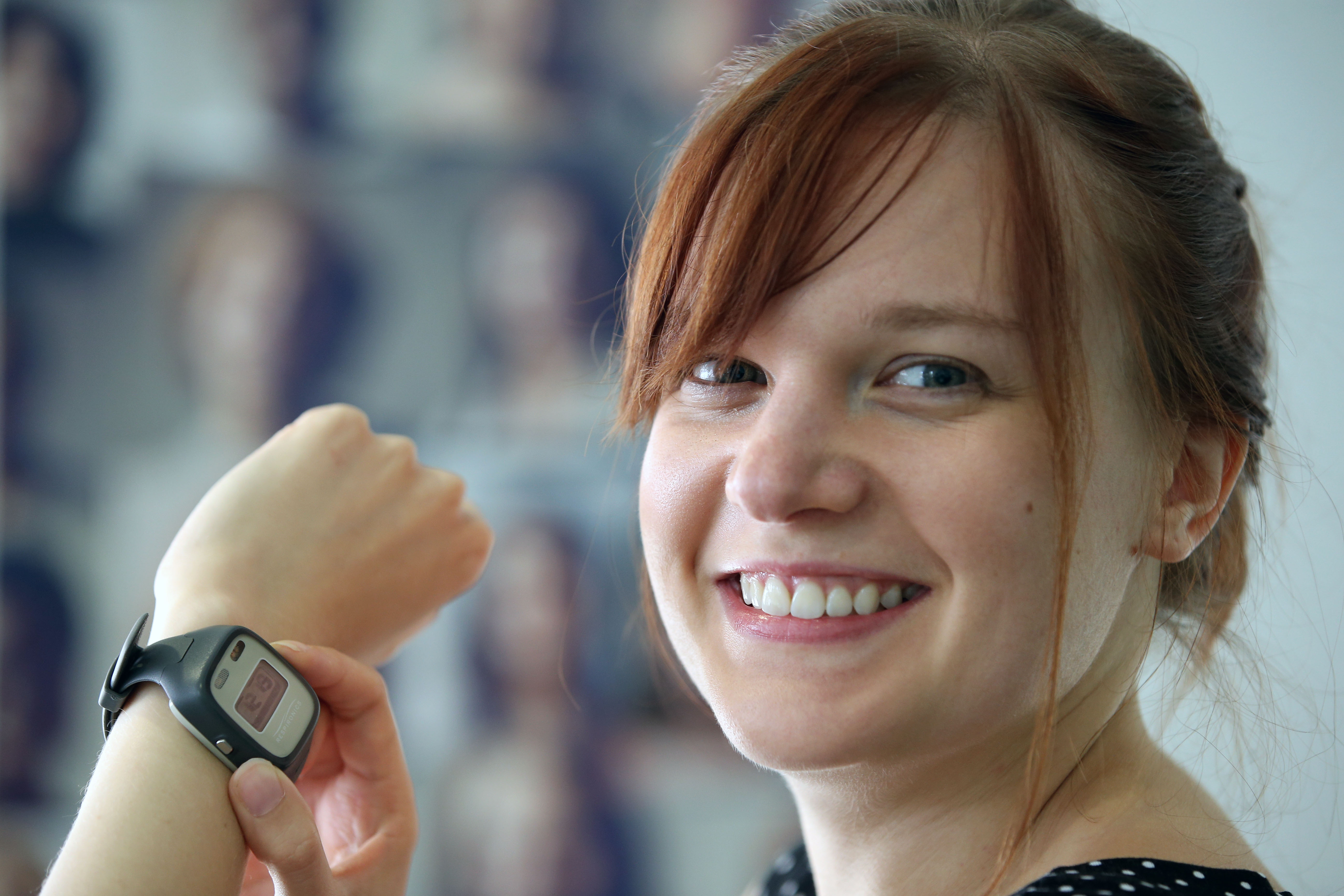 Photograph of Katie Lewis demonstrating a watch used as part of her research