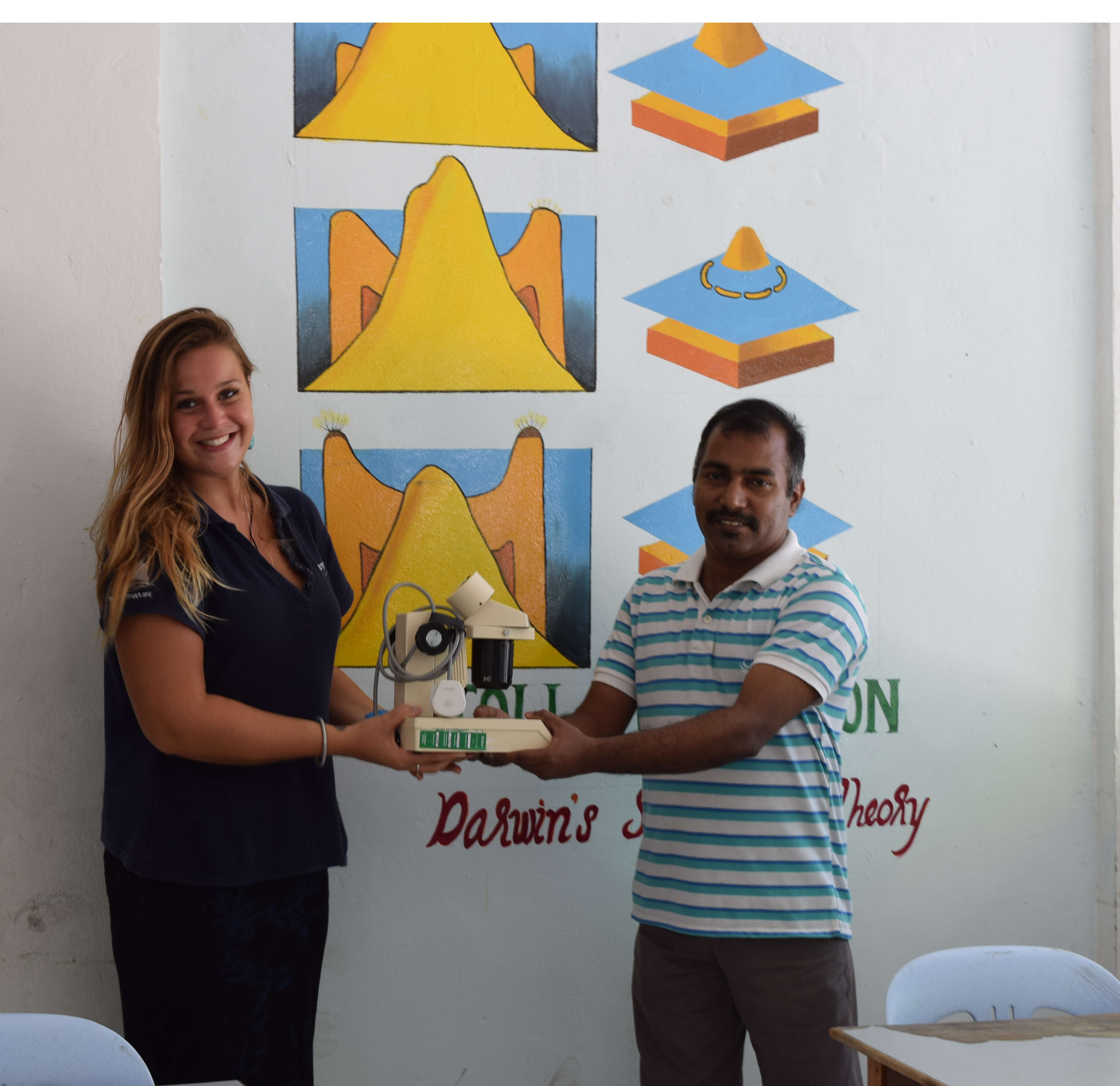 Beth Taylor presenting a microscope to Hithadoo School, Laamu Atoll