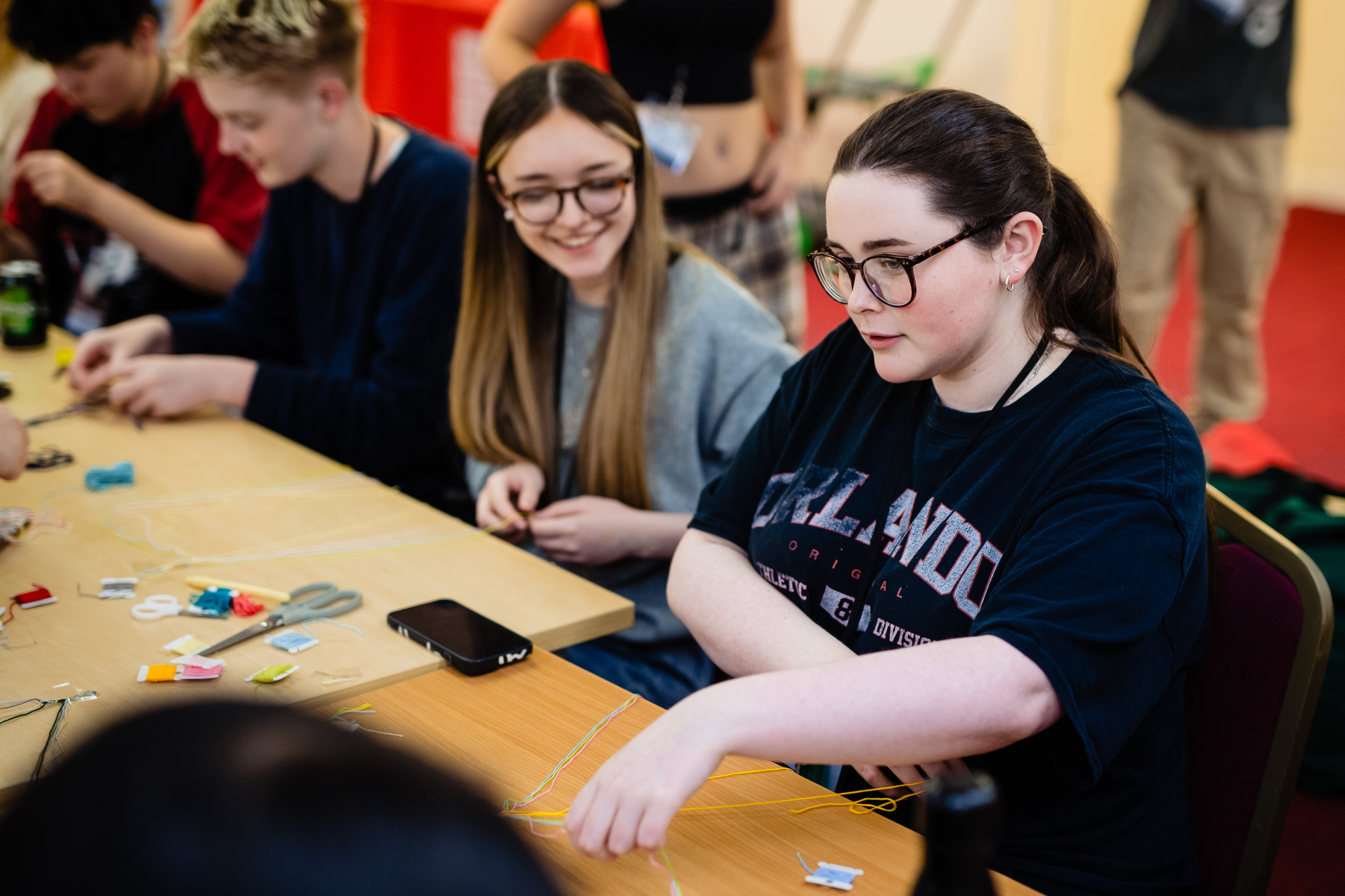 Students making friendship bracelets