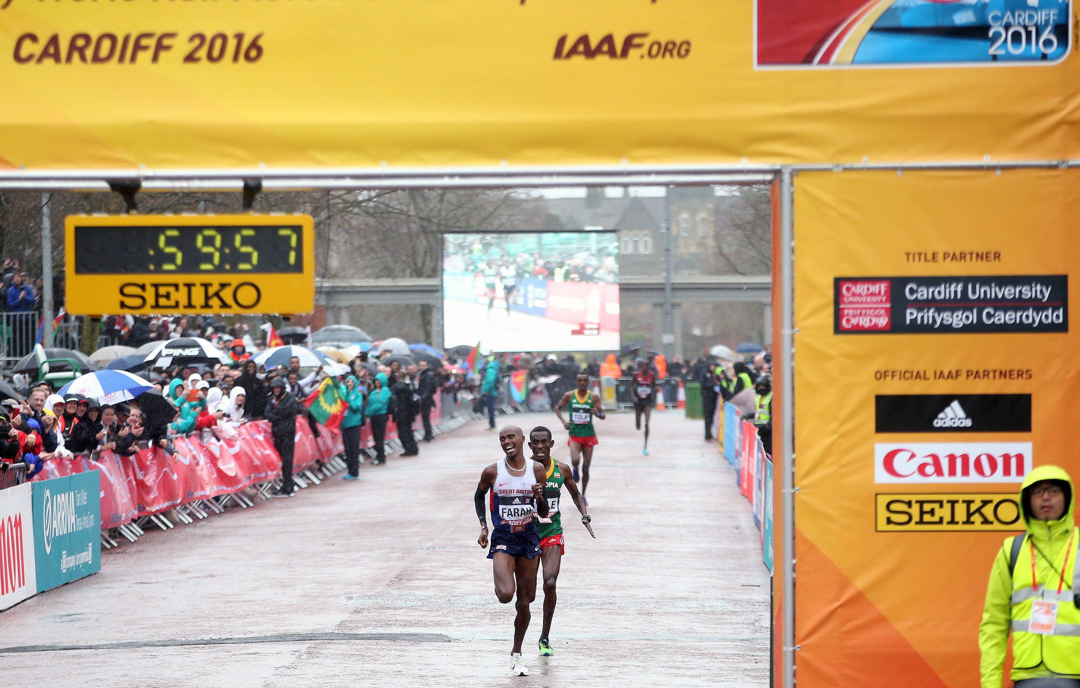 Mo Farah crosses the World Half Marathon finish line