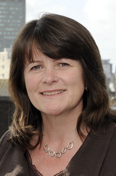 Image of a woman with dark hair smiling into the camera